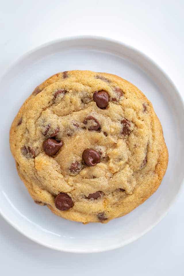 Close up chocolate chip cookie on a white plate