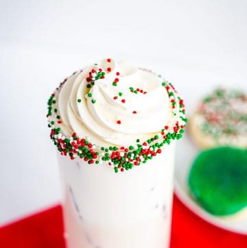 sprinkle rimmed sugar cookie cocktail with whipped cream