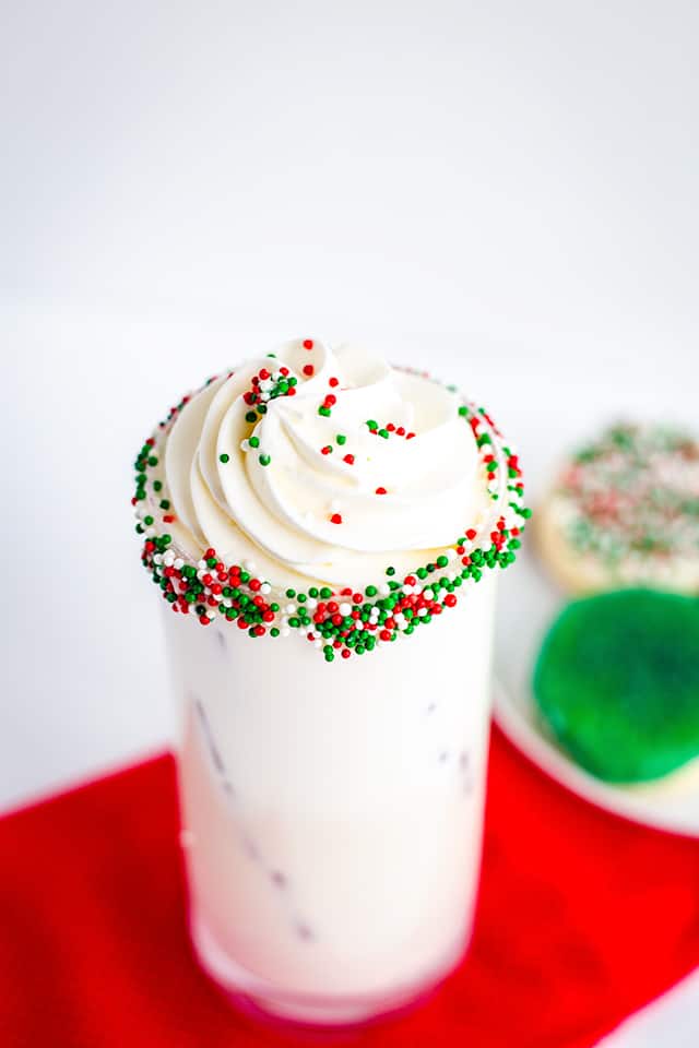 sprinkle rimmed sugar cookie cocktail with whipped cream
