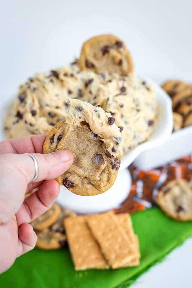 dipping a cookie in cookie dough dip
