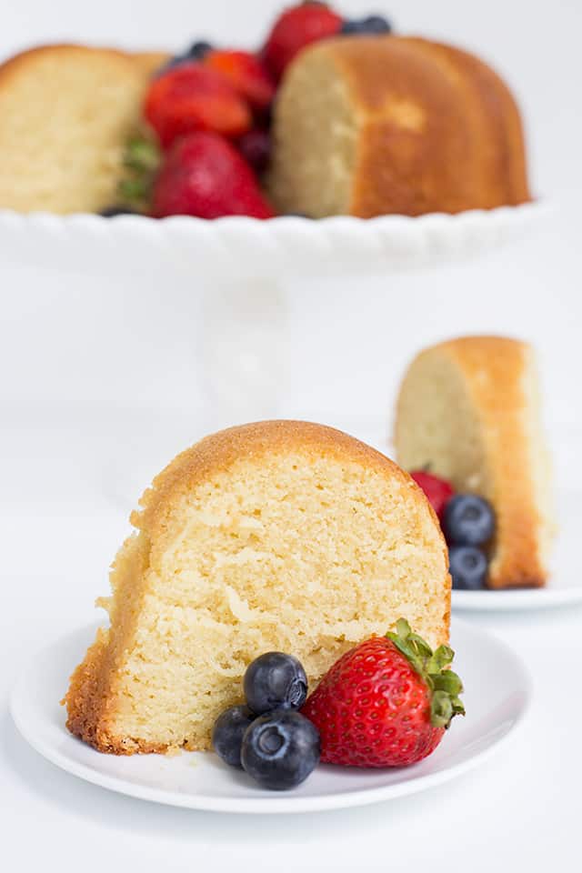 close up of slice of vanilla pound cake with berries