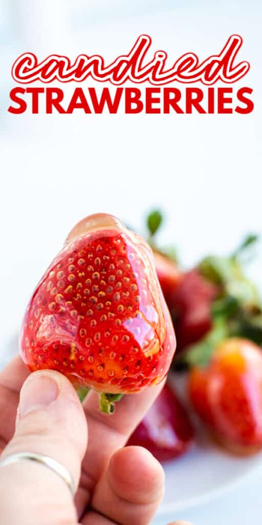 A person with candied strawberries.