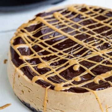 instant pot peanut butter cheesecake with peanut butter drizzle on the sides