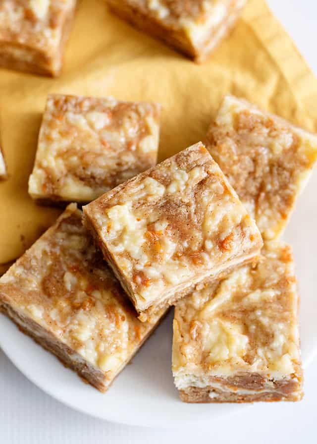 overhead shot of carrot cake bars on yellow linen