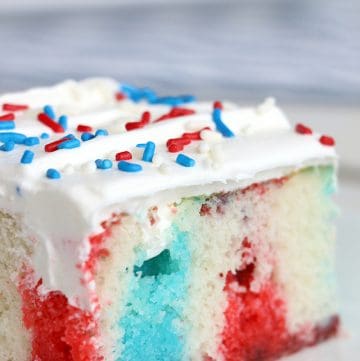 slice of red white and blue poke cake on white plate