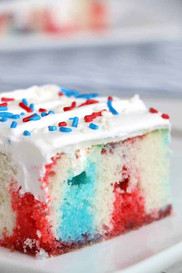 slice of red white and blue poke cake on white plate