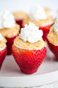 side of cheesecake stuffed strawberry with whipped cream