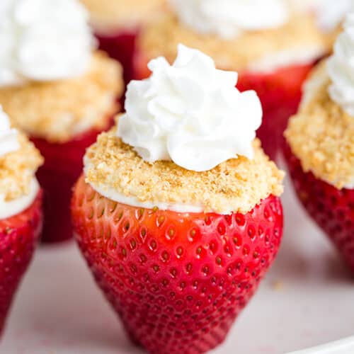 side of cheesecake stuffed strawberry with whipped cream
