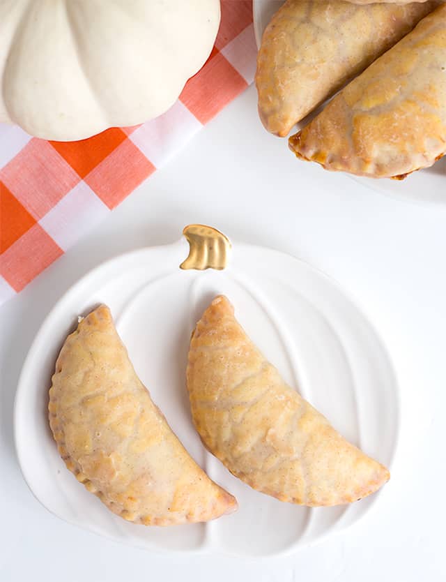 Pumpkin Pasties - These Harry Potter Pumpkin Pasties are perfect for this cool, fall weather. You're probably thinking, those are Pumpkin Hand Pies and you're not wrong! Each pie is stuffed with a pumpkin pie filling, baked to perfection, then dipped in maple cinnamon glaze! If you're looking for an easy pumpkin pasties recipe, you've found it! #cookiedoughandovenmitt #HarryPotter #pumpkinsdesserts #pumpkinrecipes #fallrecipes #falldesserts