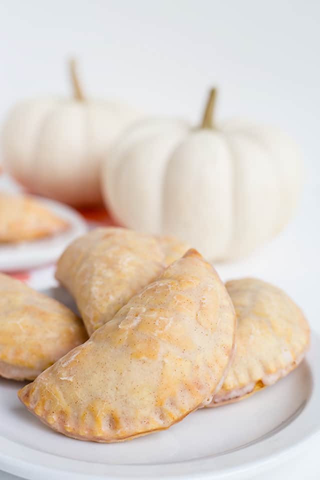 Pumpkin Pasties - These Harry Potter Pumpkin Pasties are perfect for this cool, fall weather. You're probably thinking, those are Pumpkin Hand Pies and you're not wrong! Each pie is stuffed with a pumpkin pie filling, baked to perfection, then dipped in maple cinnamon glaze! If you're looking for an easy pumpkin pasties recipe, you've found it! #cookiedoughandovenmitt #HarryPotter #pumpkinsdesserts #pumpkinrecipes #fallrecipes #falldesserts