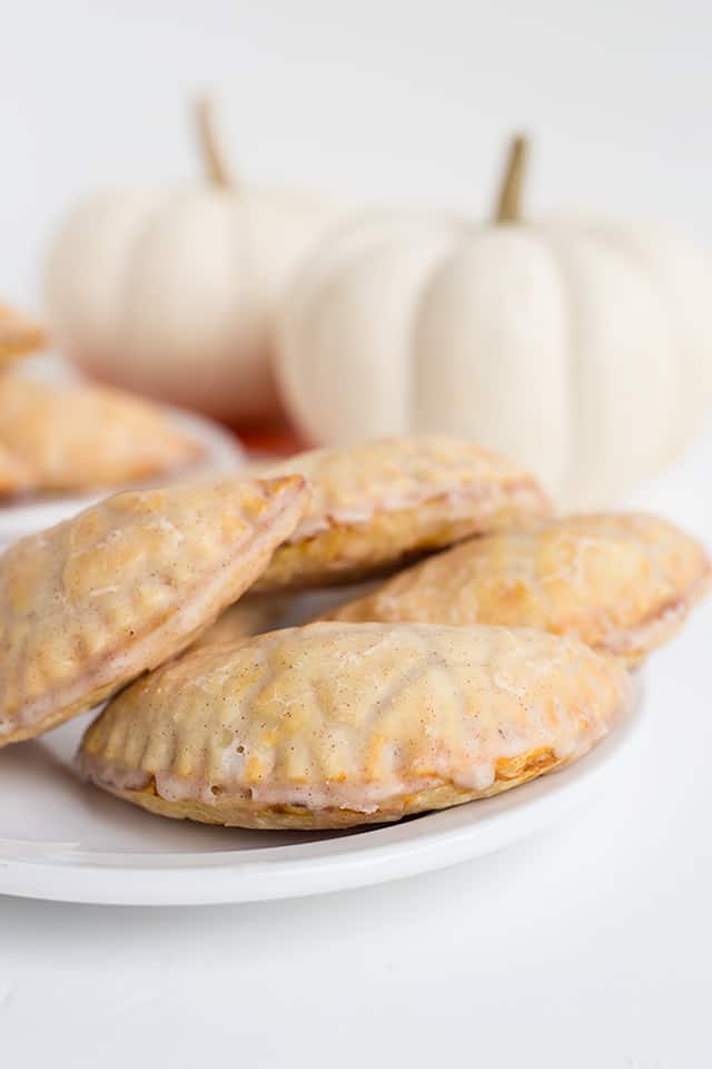 Pumpkin Pasties - These Harry Potter Pumpkin Pasties are perfect for this cool, fall weather. You're probably thinking, those are Pumpkin Hand Pies and you're not wrong! Each pie is stuffed with a pumpkin pie filling, baked to perfection, then dipped in maple cinnamon glaze! If you're looking for an easy pumpkin pasties recipe, you've found it! #cookiedoughandovenmitt #HarryPotter #pumpkinsdesserts #pumpkinrecipes #fallrecipes #falldesserts