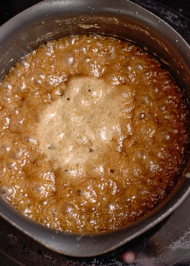homemade caramel sauce boiling in a saucepan