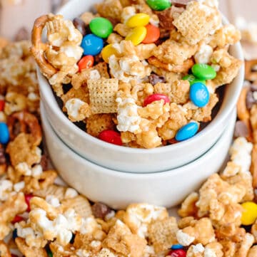 small bowl overflowing with caramel chex mix