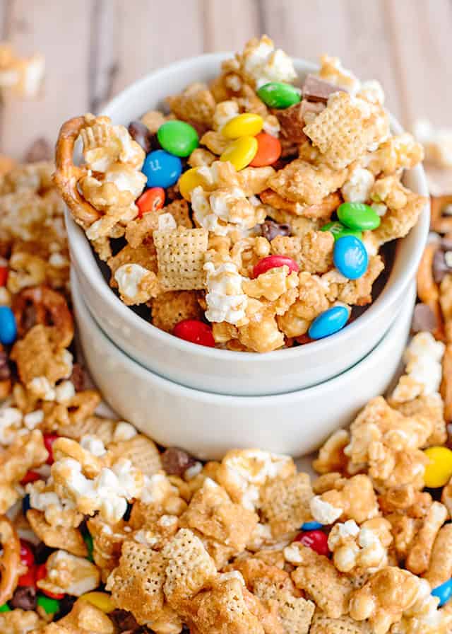 small bowl overflowing with caramel chex mix