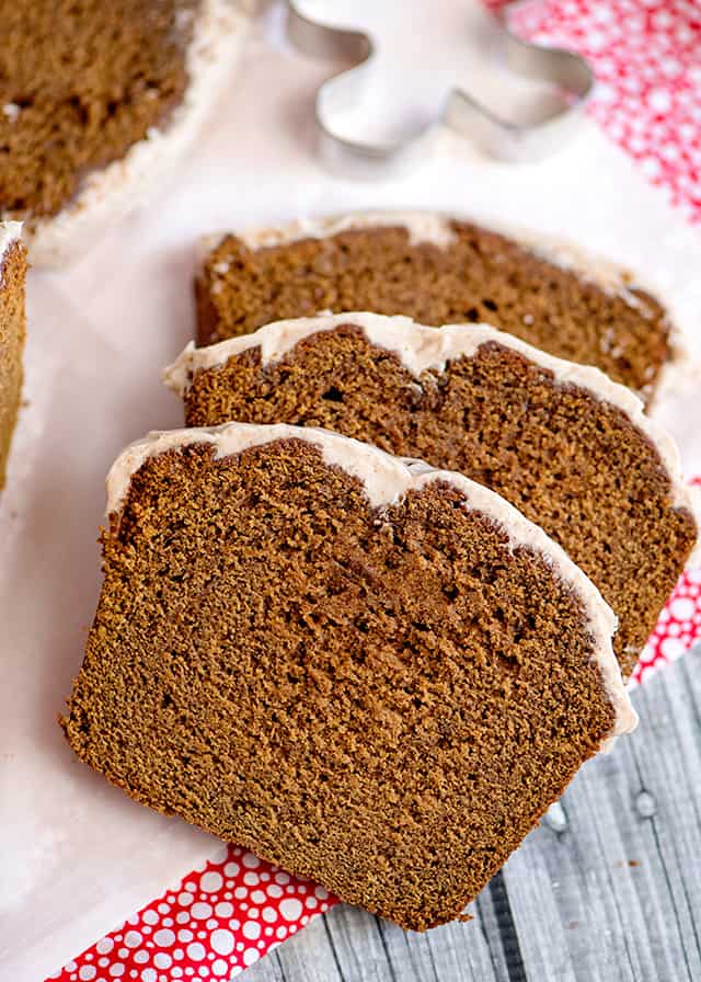 three slices of gingerbread loaf on parchment paper and pink fabric