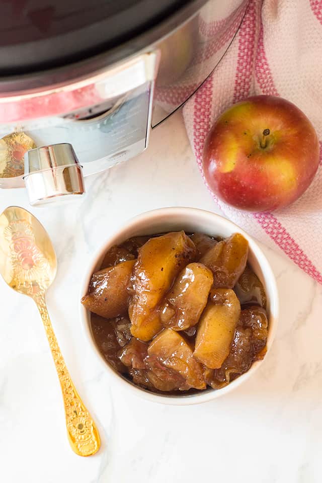 overhead photo of instant pot cinnamon apples with apple and gold spoon