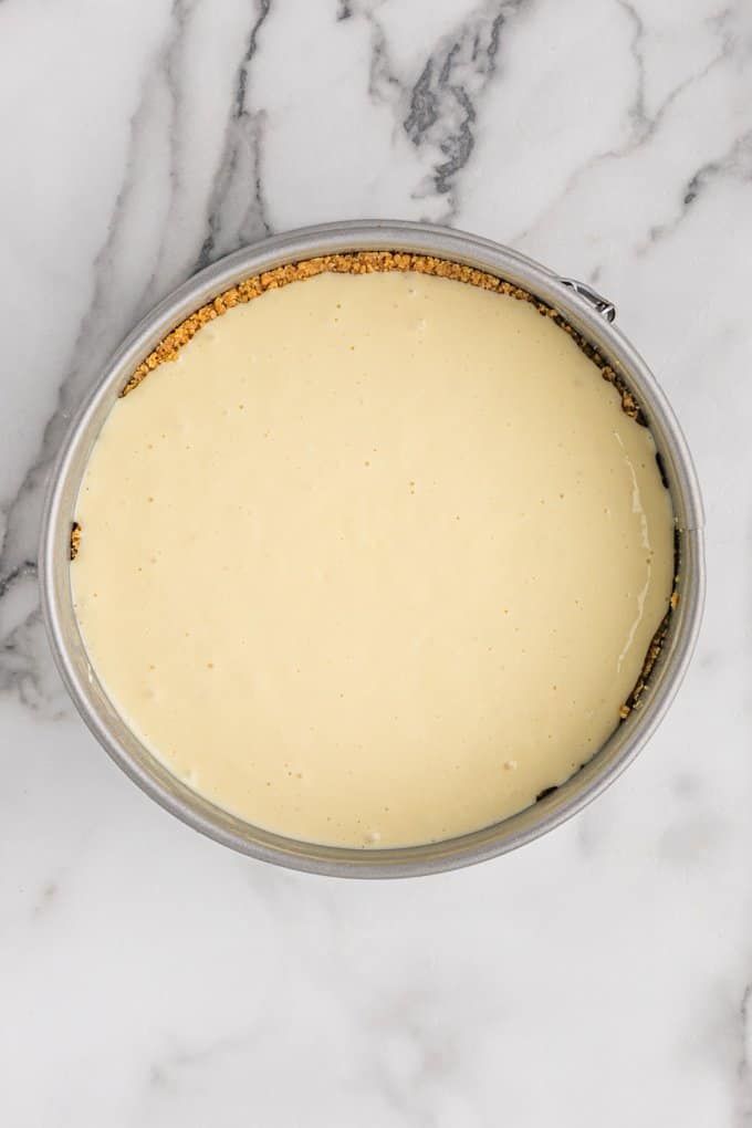 overhead image of the baked cheesecake on a marble surface