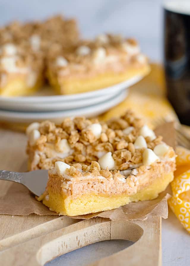 cutting the slice of sweet potato cheesecake bars with a fork