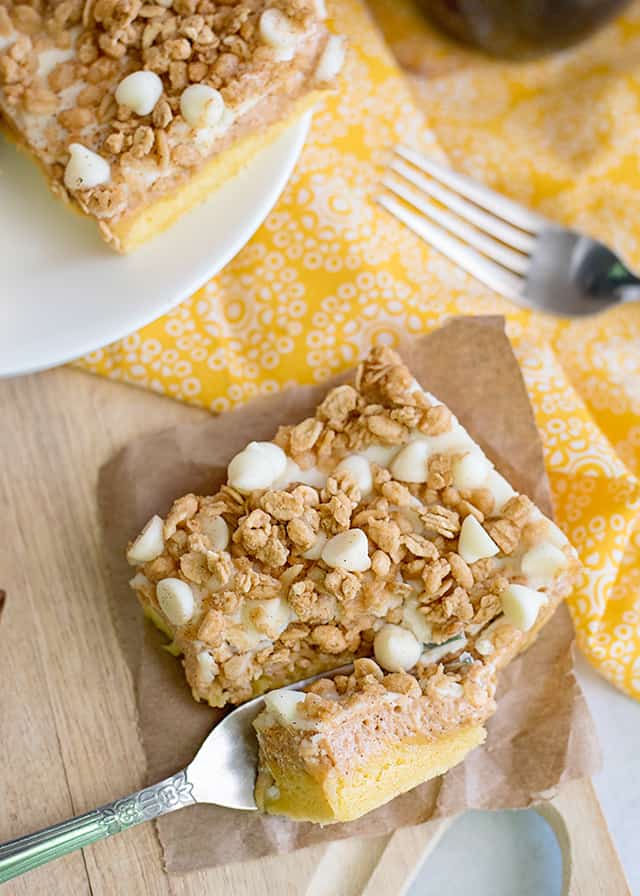 overhead photo of cutting a piece of sweet potato cheesecake squares with a fork