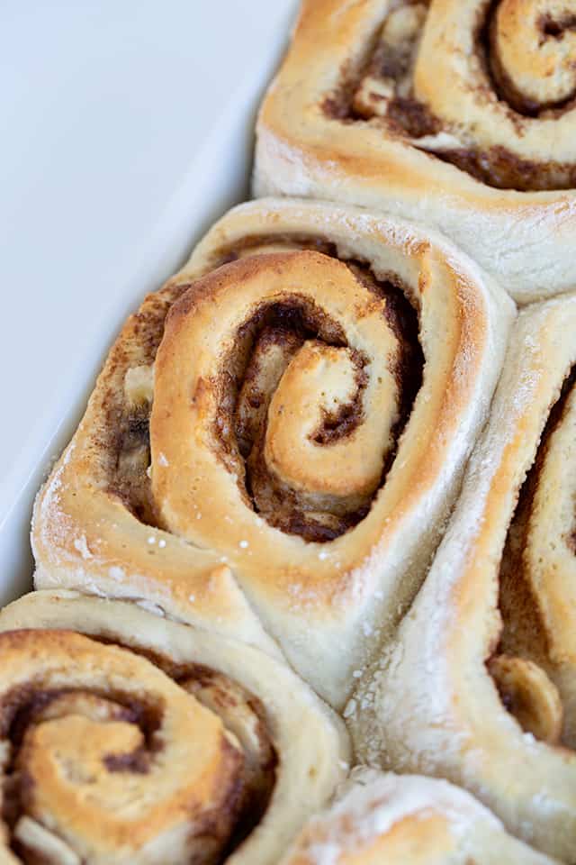 Close up of pan of bananas foster cinnamon rolls without frosting