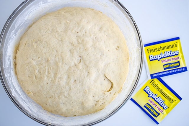 Dough that's been rising in a glass bowl