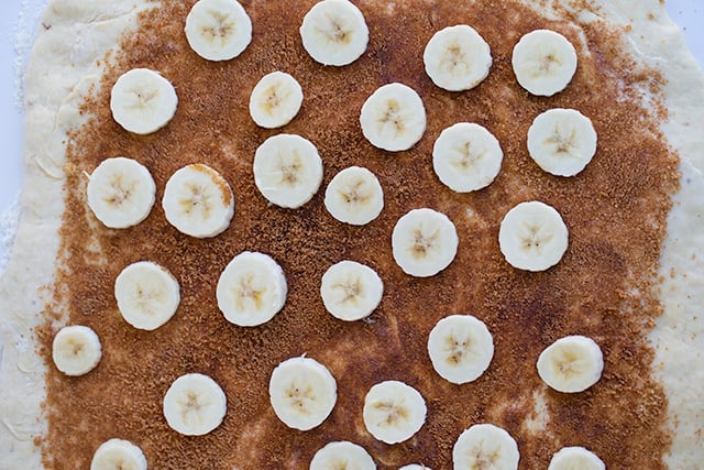 sweet dough rolled out with brown sugar and bananas on top