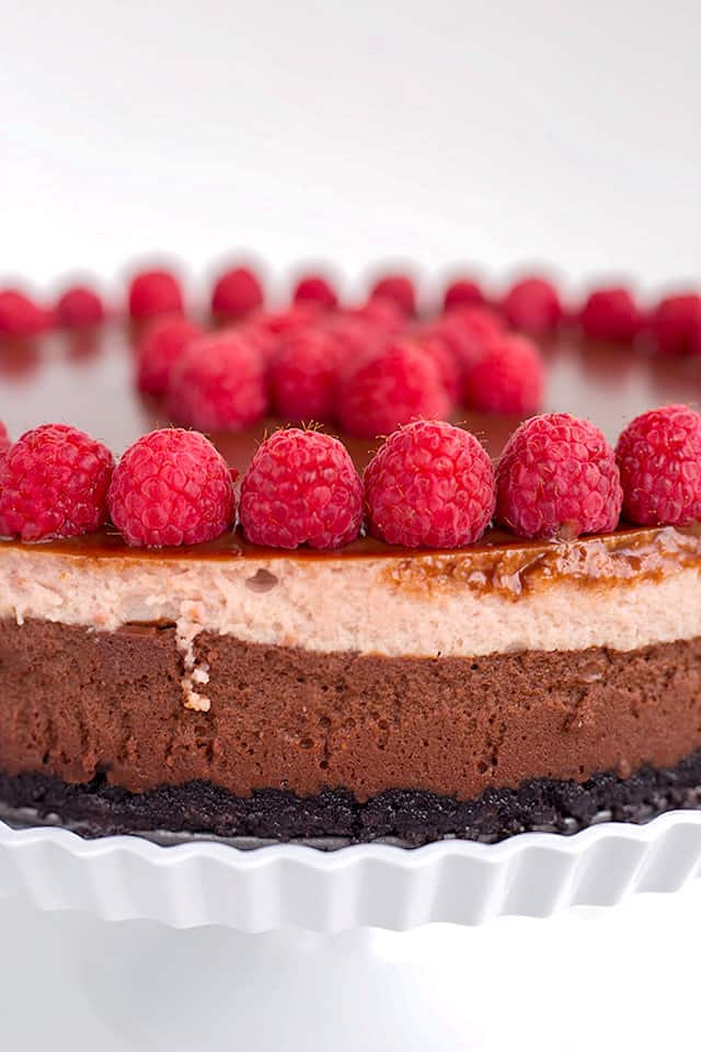 Close up of side of the chocolate raspberry cheesecake showing the chocolate and raspberry layers