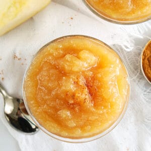 overhead photo of instant pot applesauce with a white linen and spoon