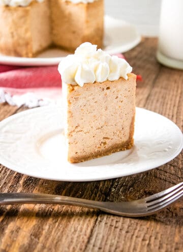 slice of instant pot sweet potato cheesecake on a white plate with fork