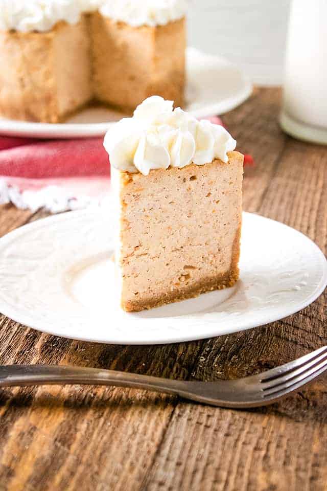slice of instant pot sweet potato cheesecake on a white plate with fork