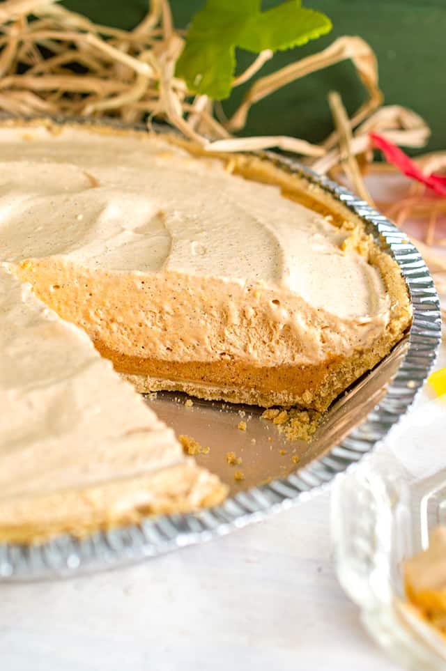 Pan of pumpkin ice cream pie with slice missing