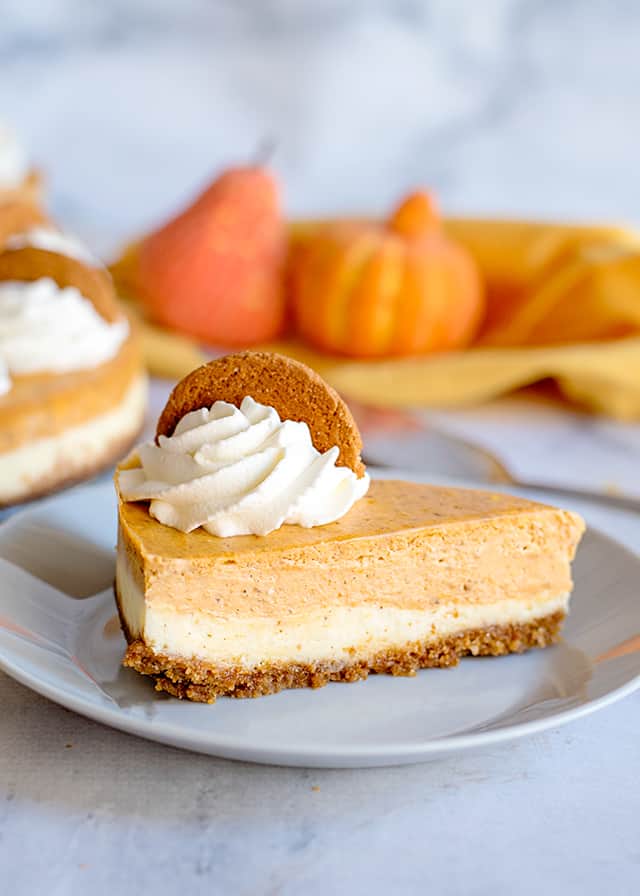slice of double layer pumpkin cheesecake on white plate