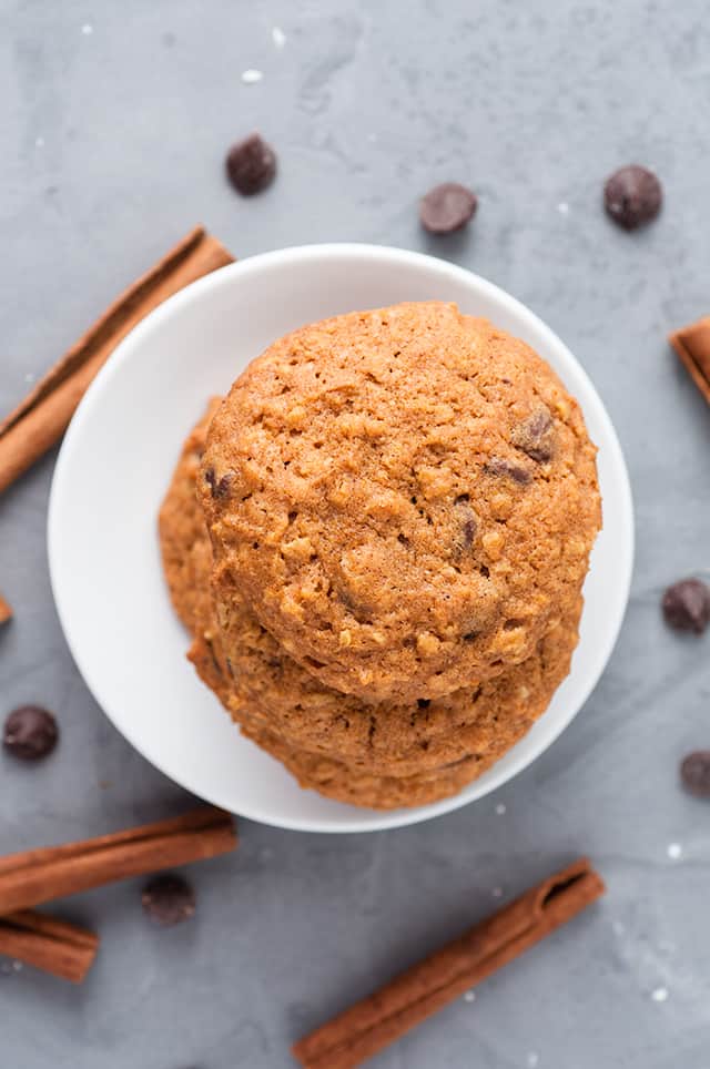 overhead photo of pumpkin oatmeal chocolate chip cookies on a white dessert plate