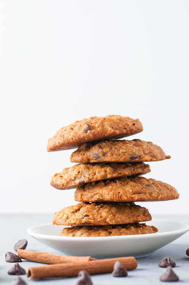 a staggered stack of pumpkin oatmeal chocolate chip cookies