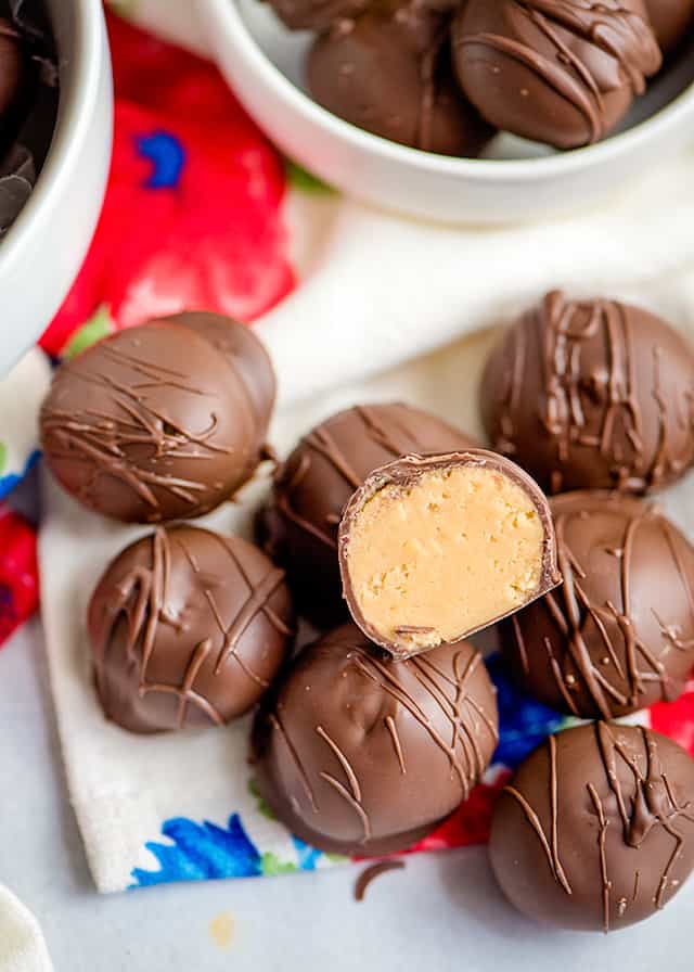 half of a peanut butter ball sitting on top of whole peanut butter balls