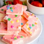 strawberry cream fudge stacked on a white plate