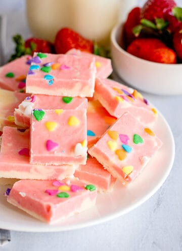 strawberry cream fudge stacked on a white plate
