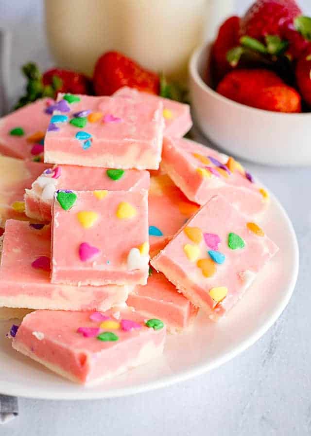 strawberry cream fudge stacked on a white plate