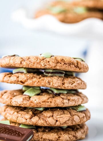 Andes mint cookies stacked on a plate with Andes mints