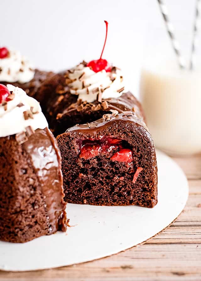 slice of cake missing from black forest bundt cake on white cake plate