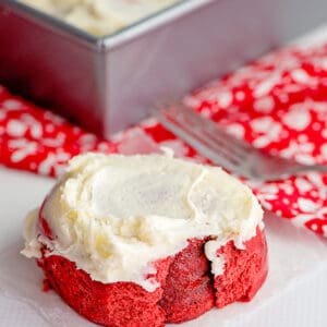 red velvet cinnamon rolls on a piece of parchment paper