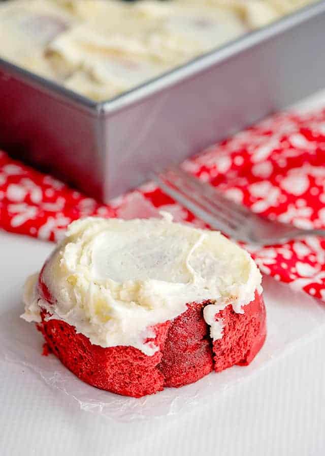red velvet cinnamon rolls on a piece of parchment paper