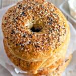 stack of homemade everything bagels with a close up on the everything bagel seasoning