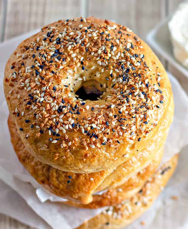 stack of homemade everything bagels with a close up on the everything bagel seasoning