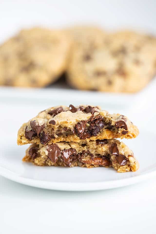 warm chocolate chip cookie on a white plate with melted chocolate