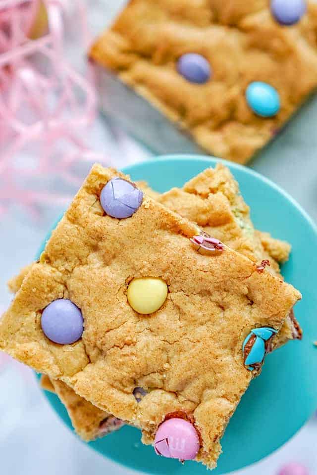 Easter Cookie Bars sitting on a blue cake plate