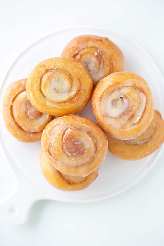 overhead view of honey buns stacked on a white plate