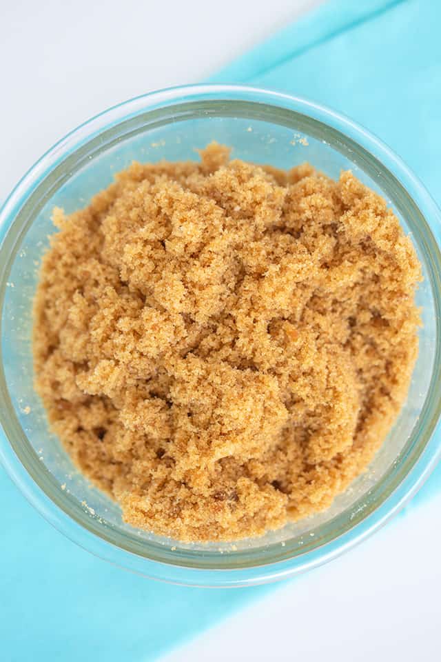 a bowl of homemade brown sugar on a blue fabric