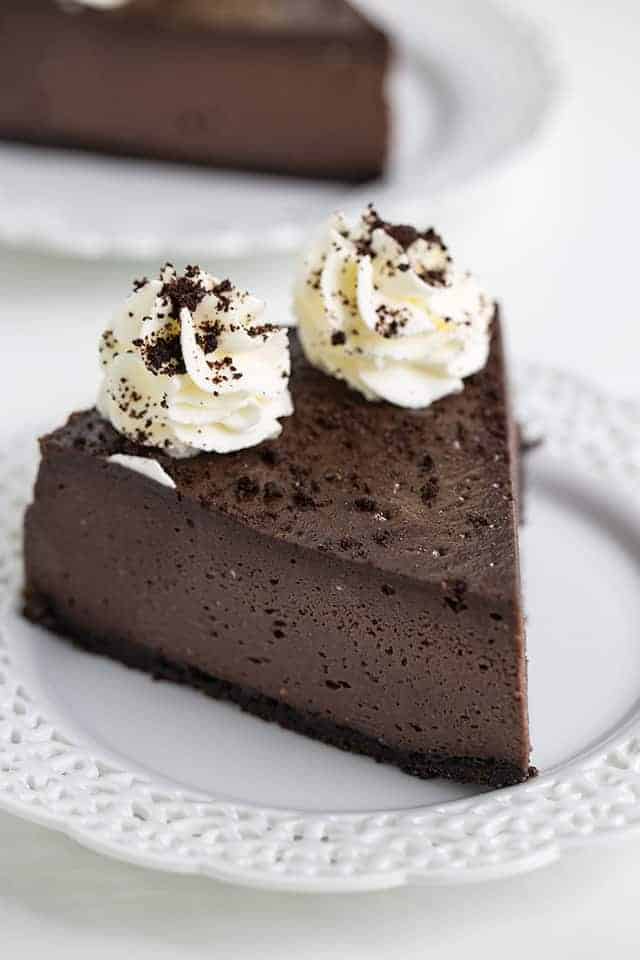 slice of oreo cheesecake on a white lace dessert plate