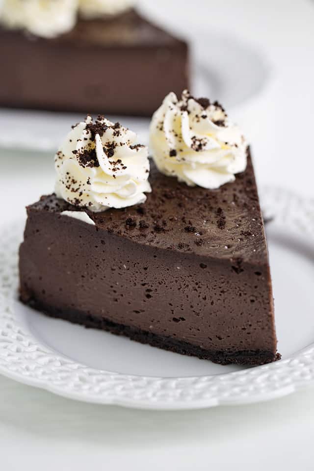 A decadent slice of Oreo cheesecake on a plate.